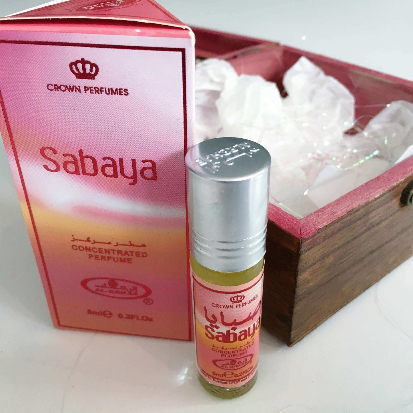 Contents view of perfume bottle and its packaging shown next to the box.