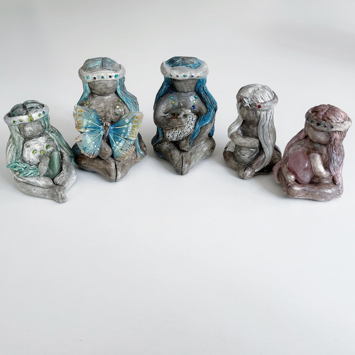 View of five different earth elementals sitting in a line.