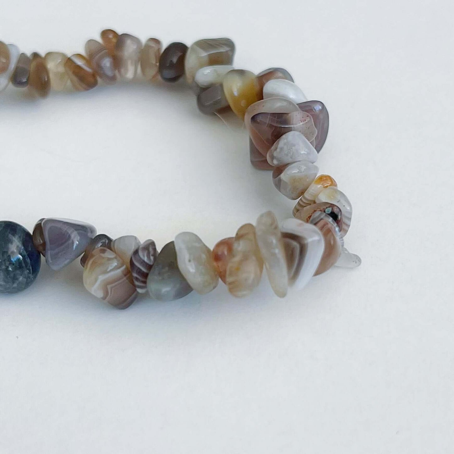 Detail view of the tumbled semi-precious stones, clear and light beige, like beach pebbles.