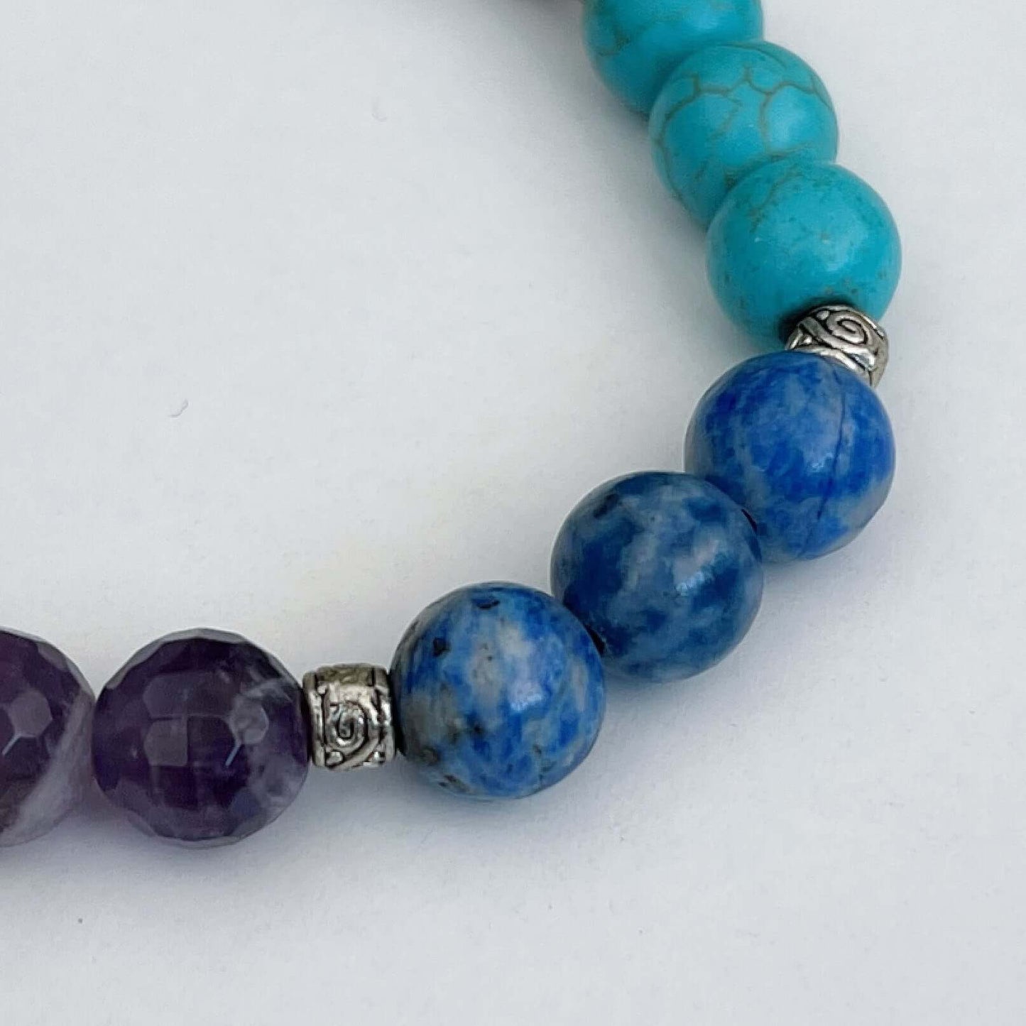 Detail view of bracelet showing Amethyst, Sodalite, Blue Howlite.
