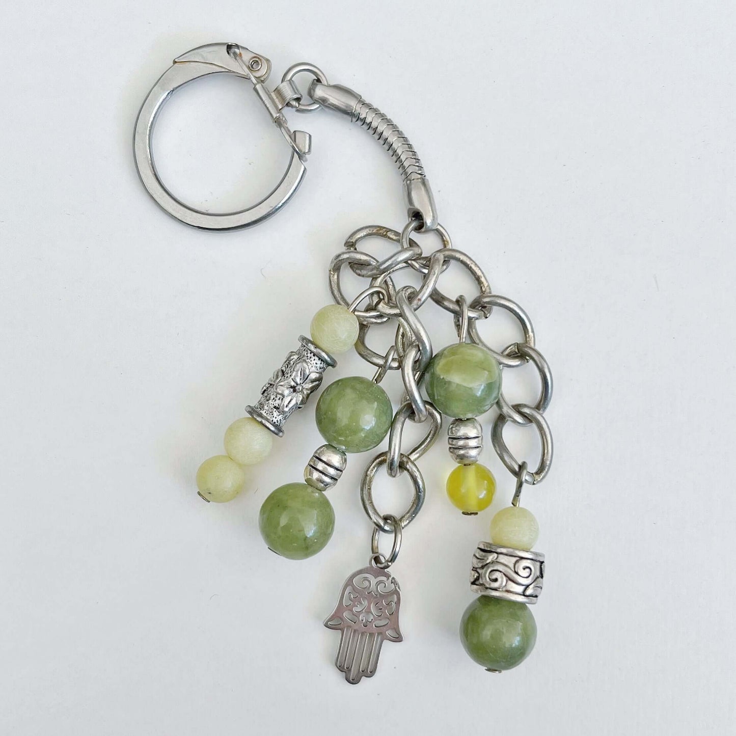 Top view of keyring showing 5 dangling chains each with beads, and one with the Hamsa charm.