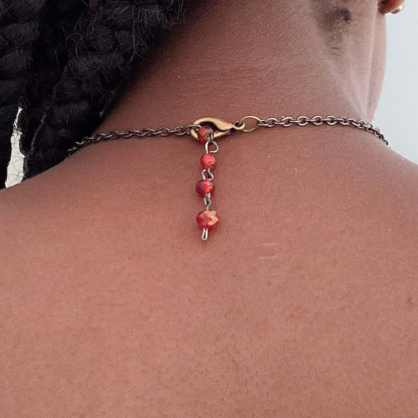 Back view of necklace showing standard clasp, with dangling beaded adjustable chain.