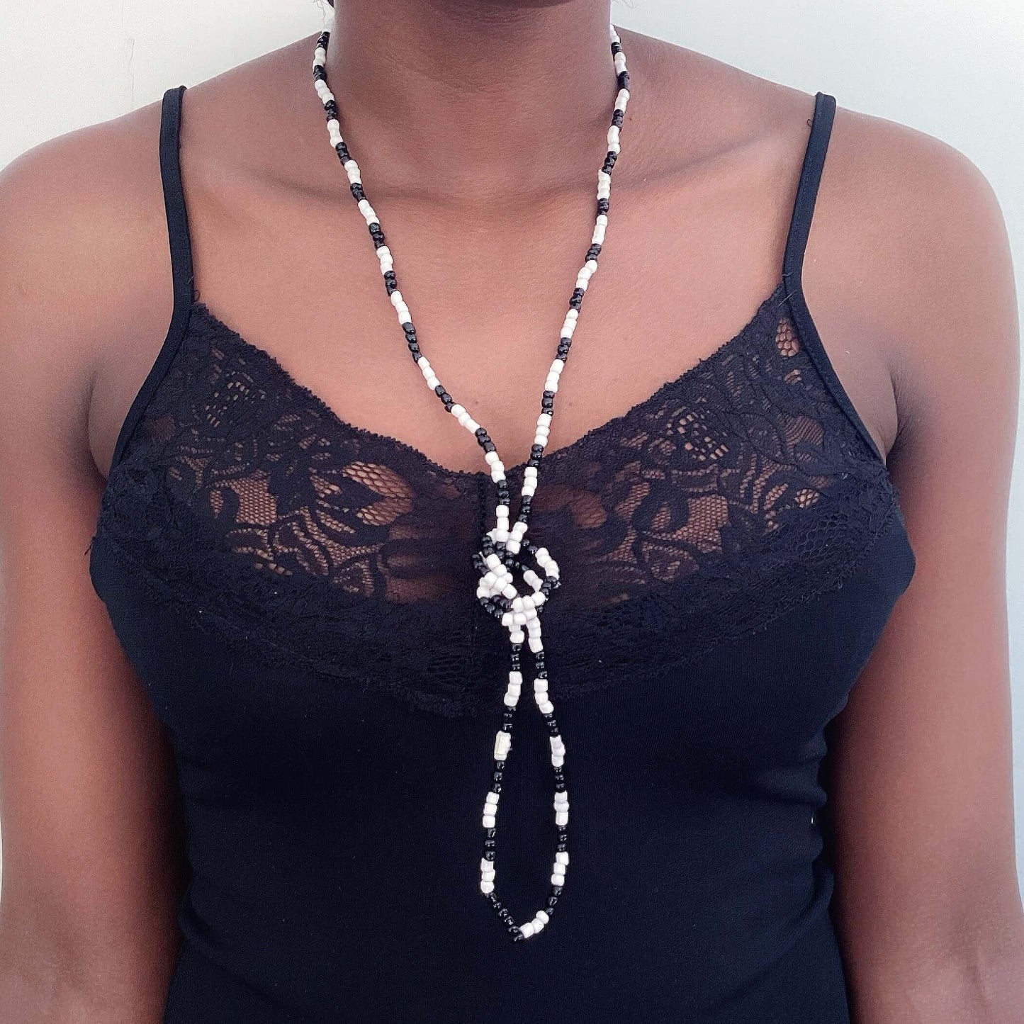 Zulu necklace tied in a knot in front, alternating black and white, approximately 3mm beads.