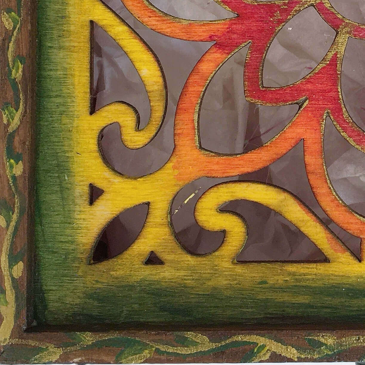 Detail view of rainbow painting fading from brown through to yellow, range, red.