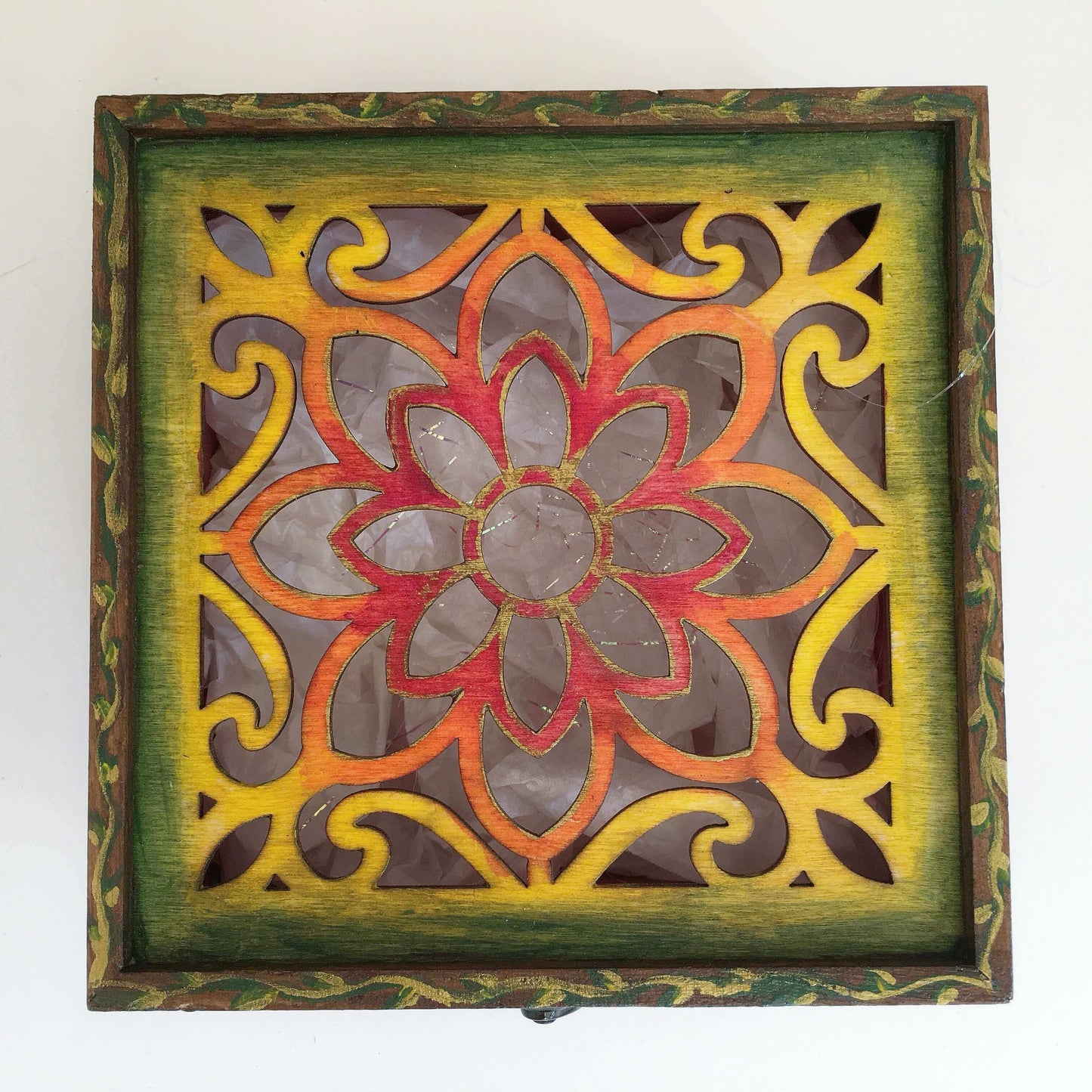 Detail view of painted rainbow lid, brown fading to red in the center.