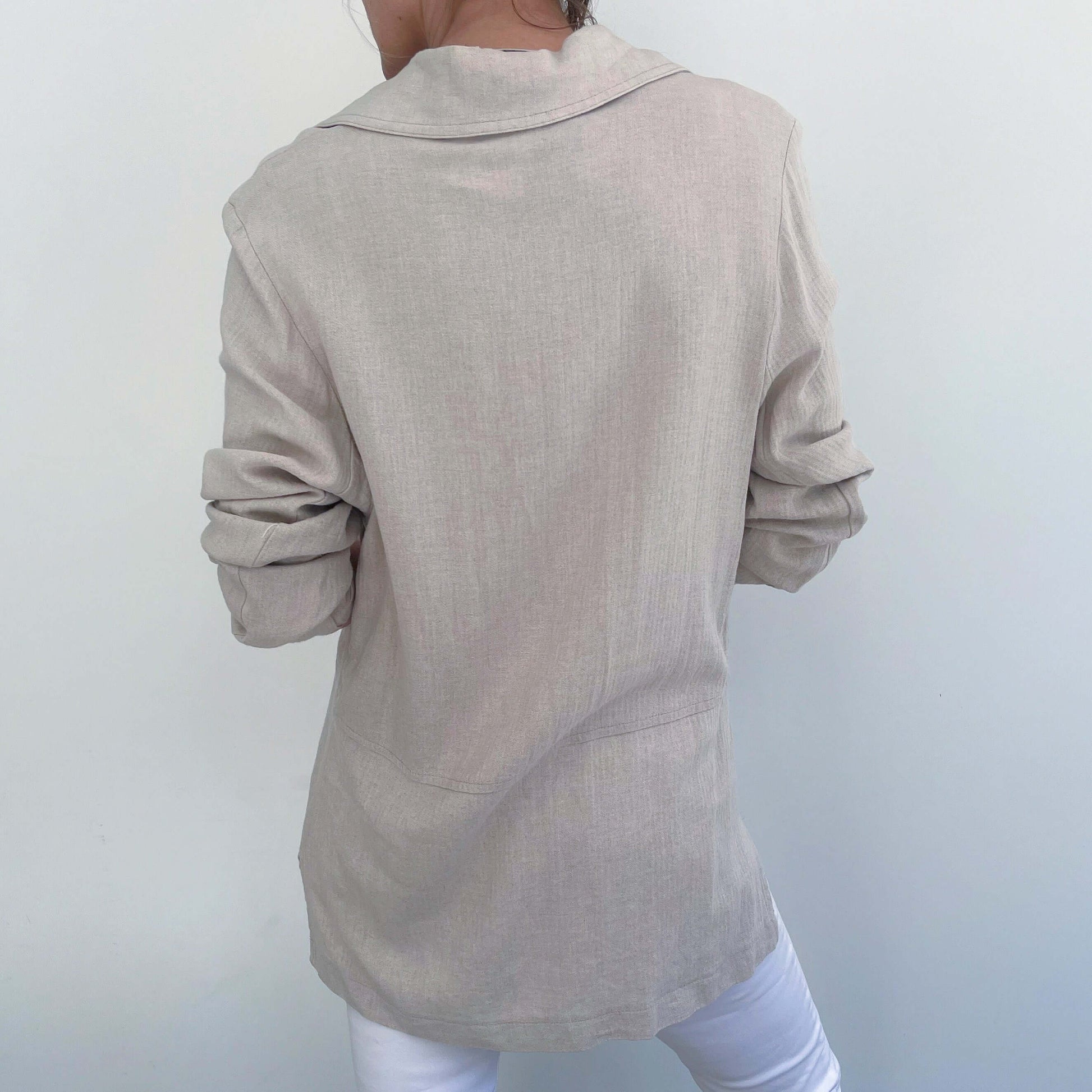 Back view of beige jacket, Upper thigh length.