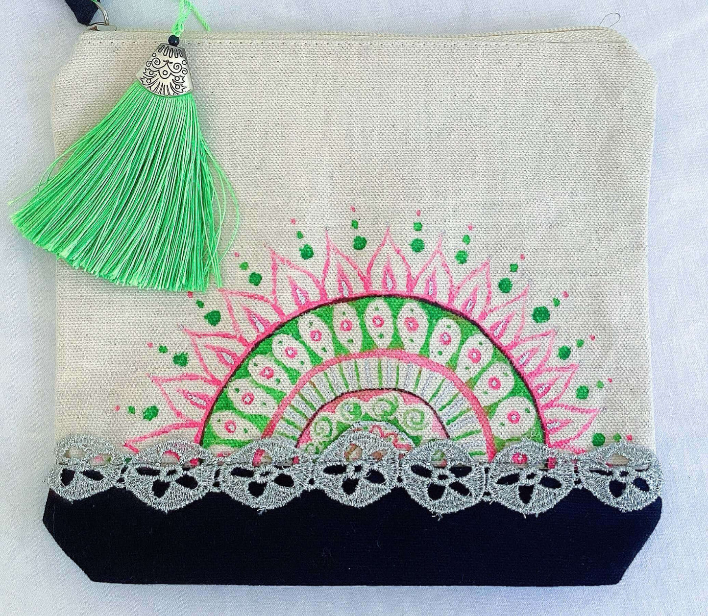 View of canvas make-up pouch, black canvas base, with hand painted green and pink half and zip.