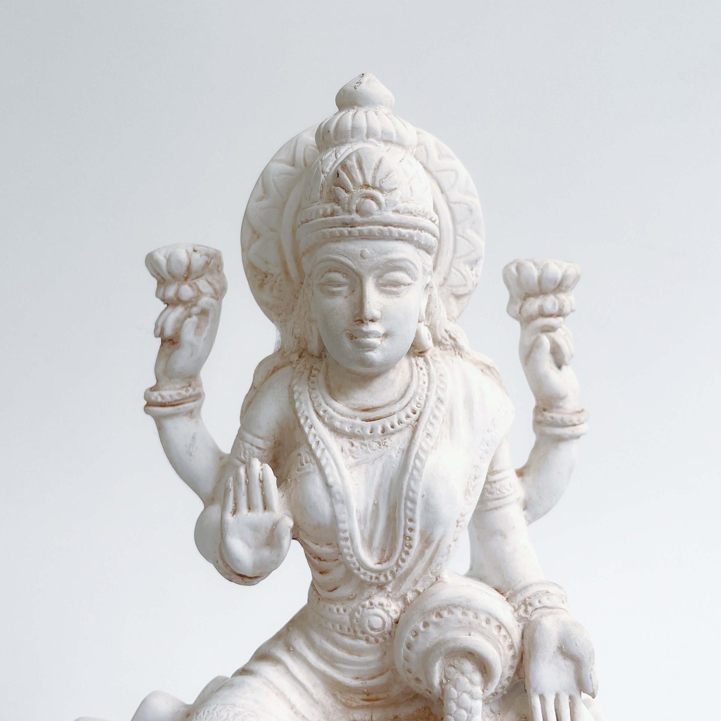 Front detail view of top half of Lakshmi, natural off white color.
