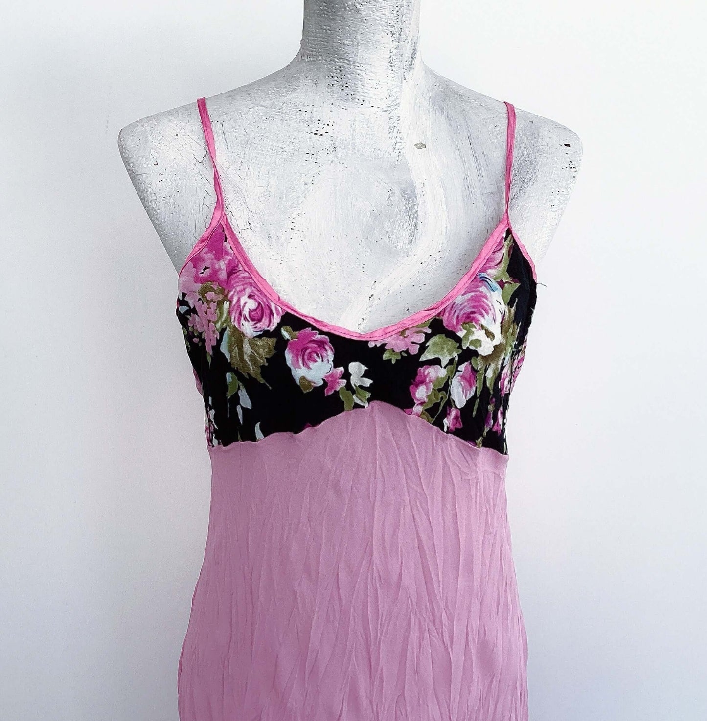 Front detail of pink georgette dress, with black, pink and green rose floral printed bust, pink satin adjustable straps.