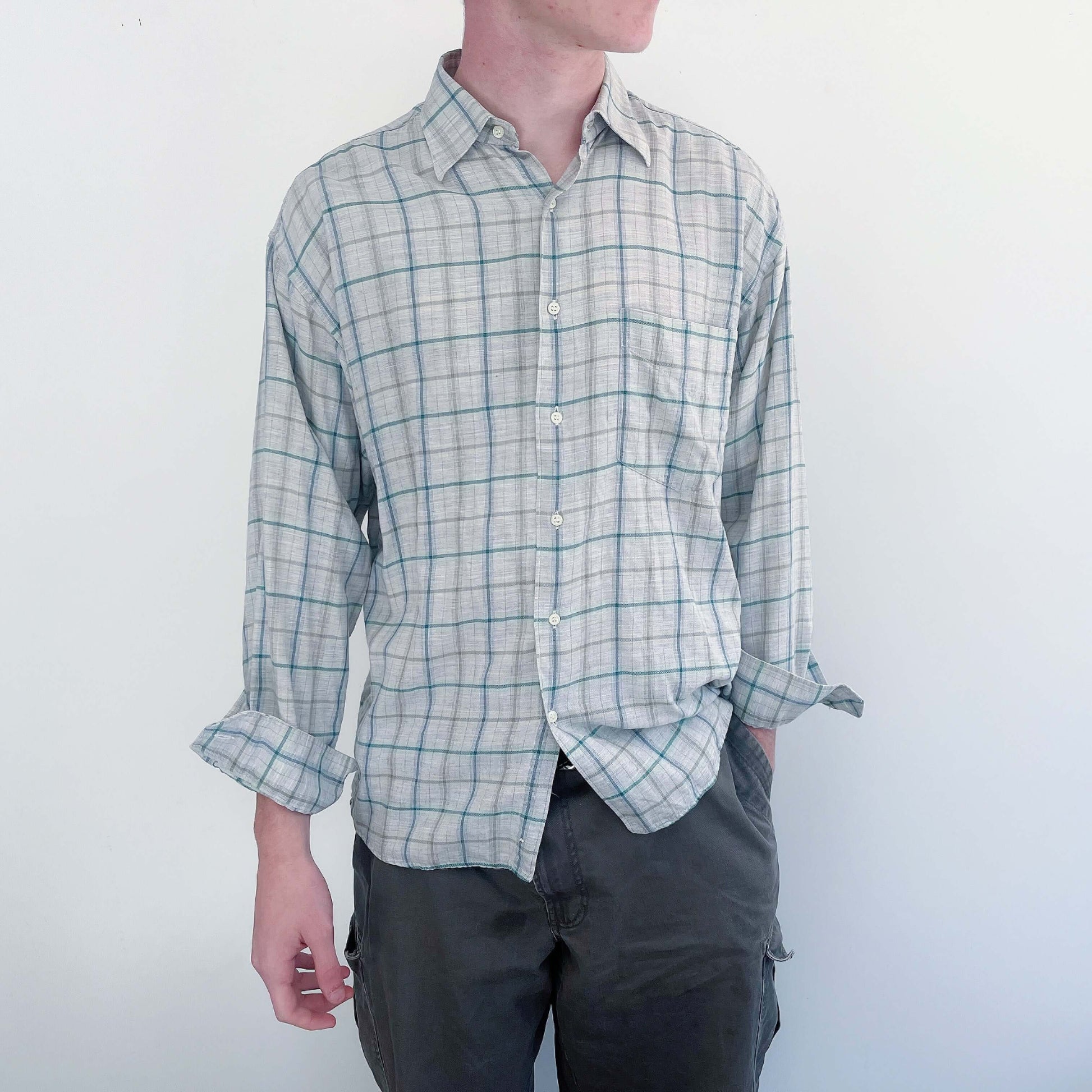 Front view of the shirt, classic button down style, pic shown with the sleeves rolled up on the model.