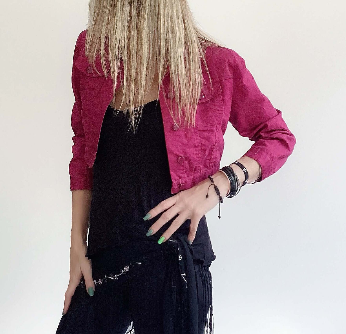 Side view of plum button up crop jacket, three quarter sleeves, side breast pocket and plum buttons.