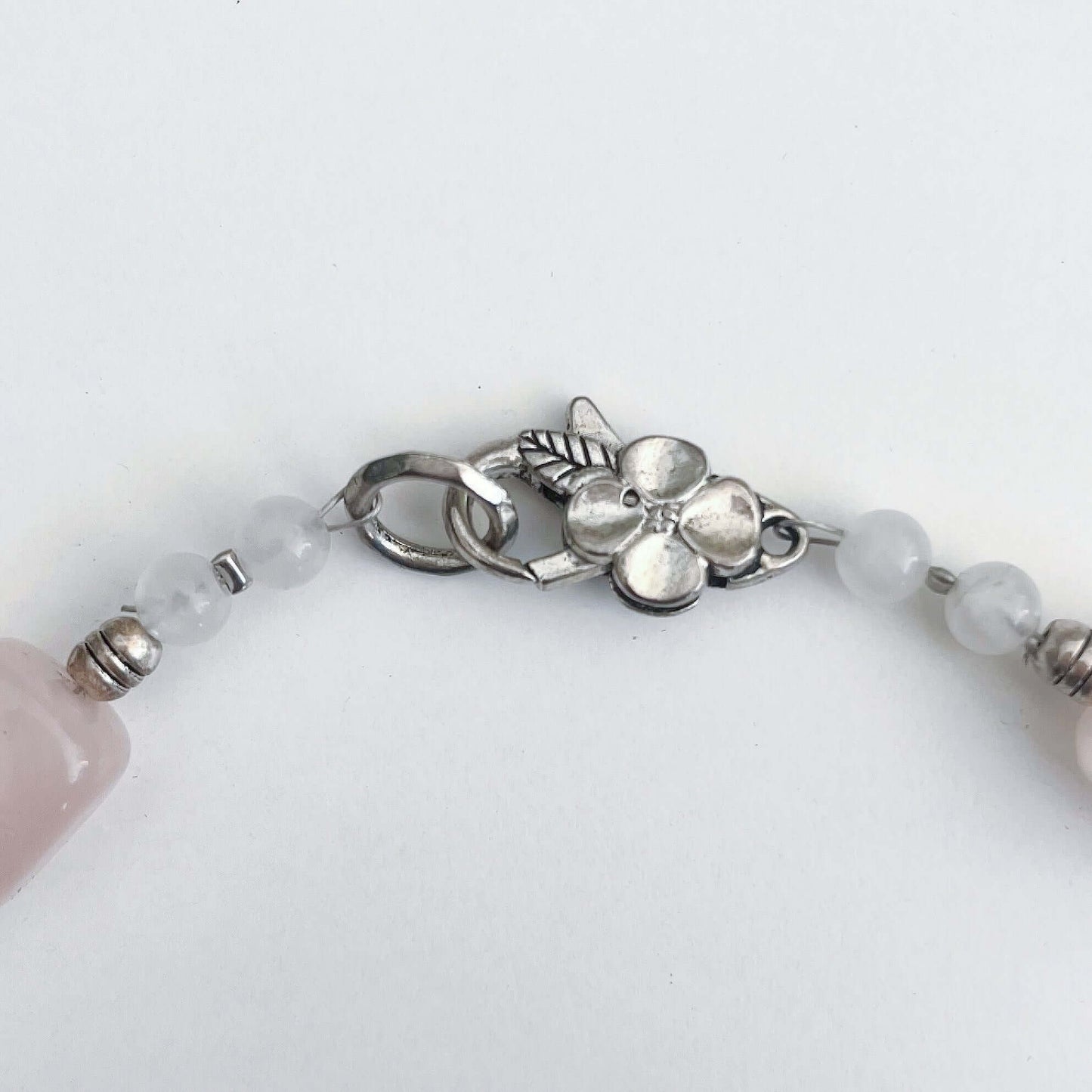 Detail view of the silver finish floral clasp.