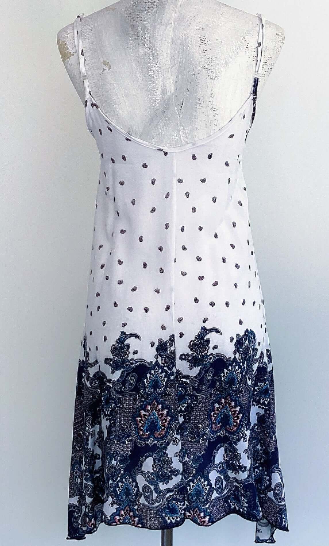 Back view of dress, top half is white with paisley print, bottom half bold navy blue paisley print.