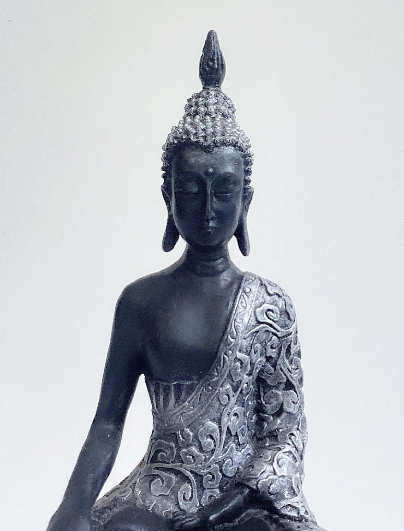 Front detail view of buddha torso, black and silver paint wash, ornate robes, with ushnisha on head.