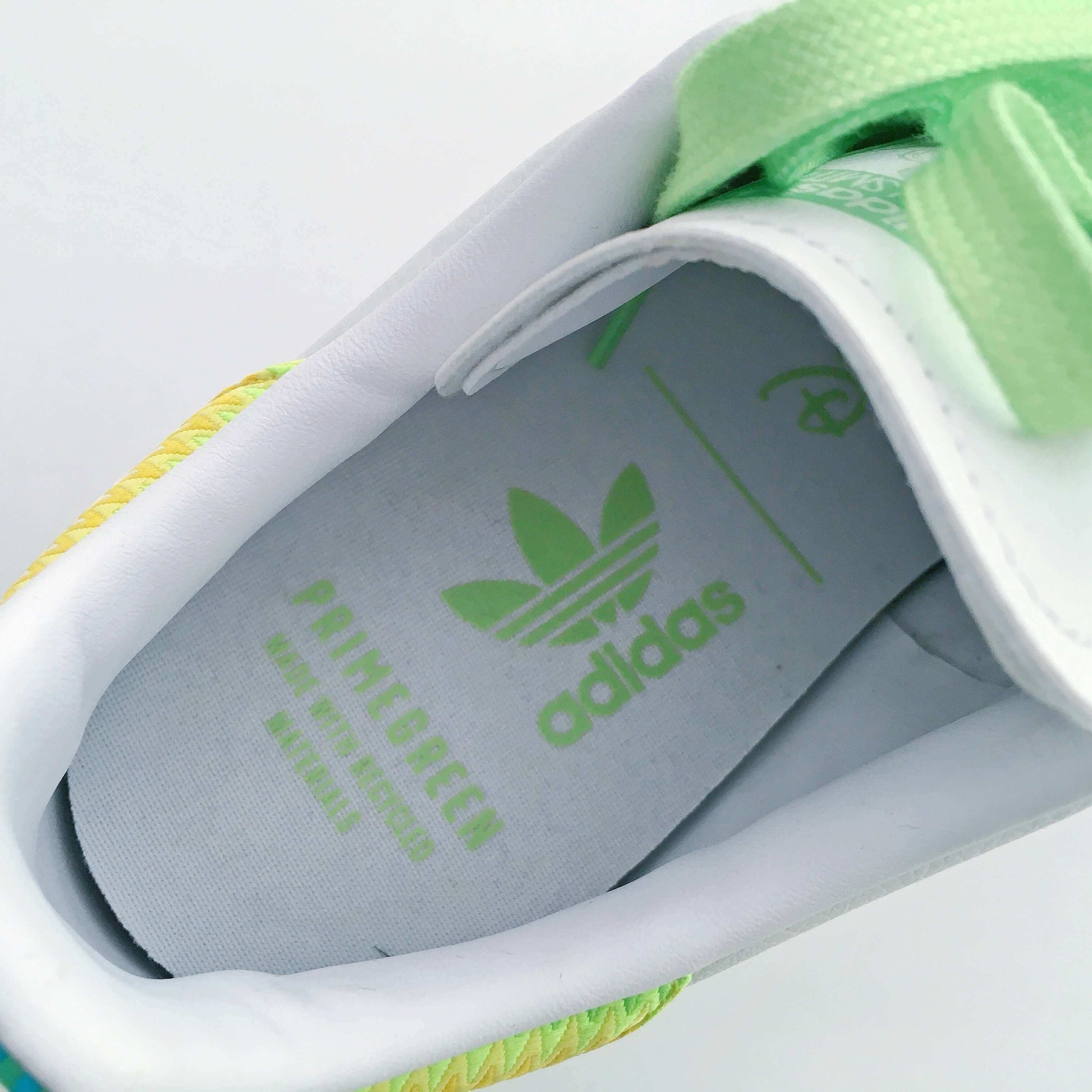 Inside view of shoe showing green printed adidas logo.