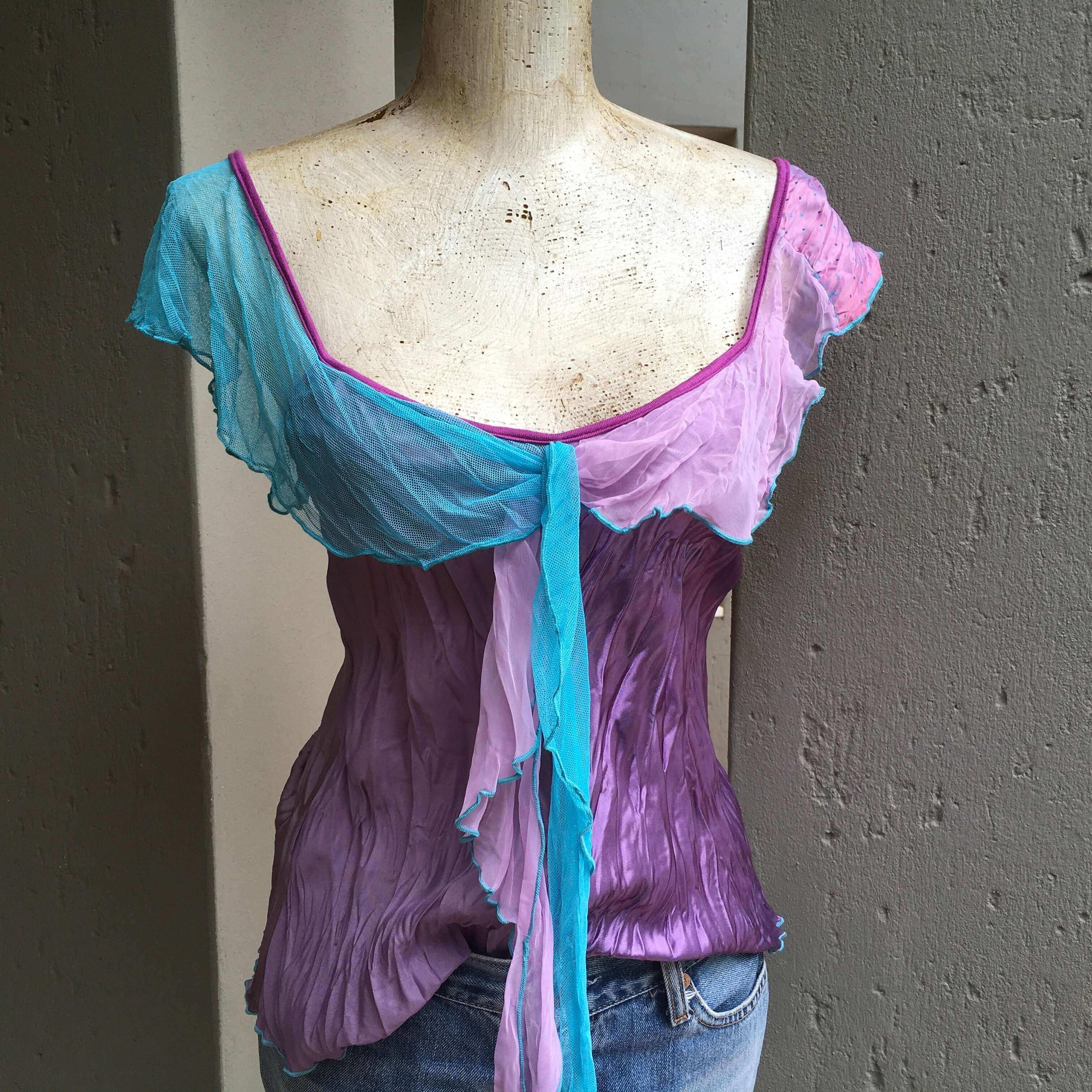 Outdoors view of camisole, worn with a pair of jeans.