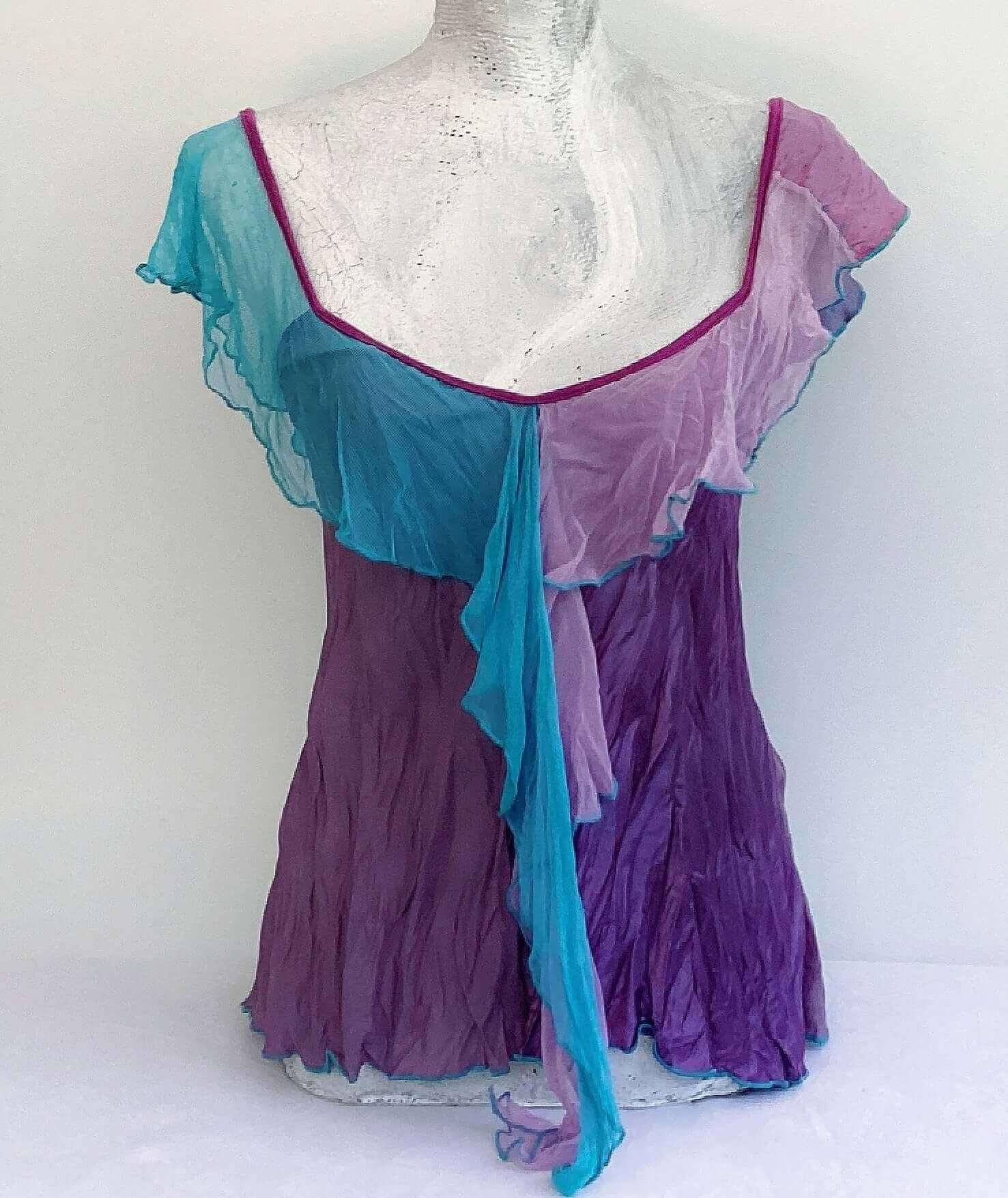 Front view of camisole, contrasting, patterned, wide chiffon frill straps, joining at center bust, flowing down in front.