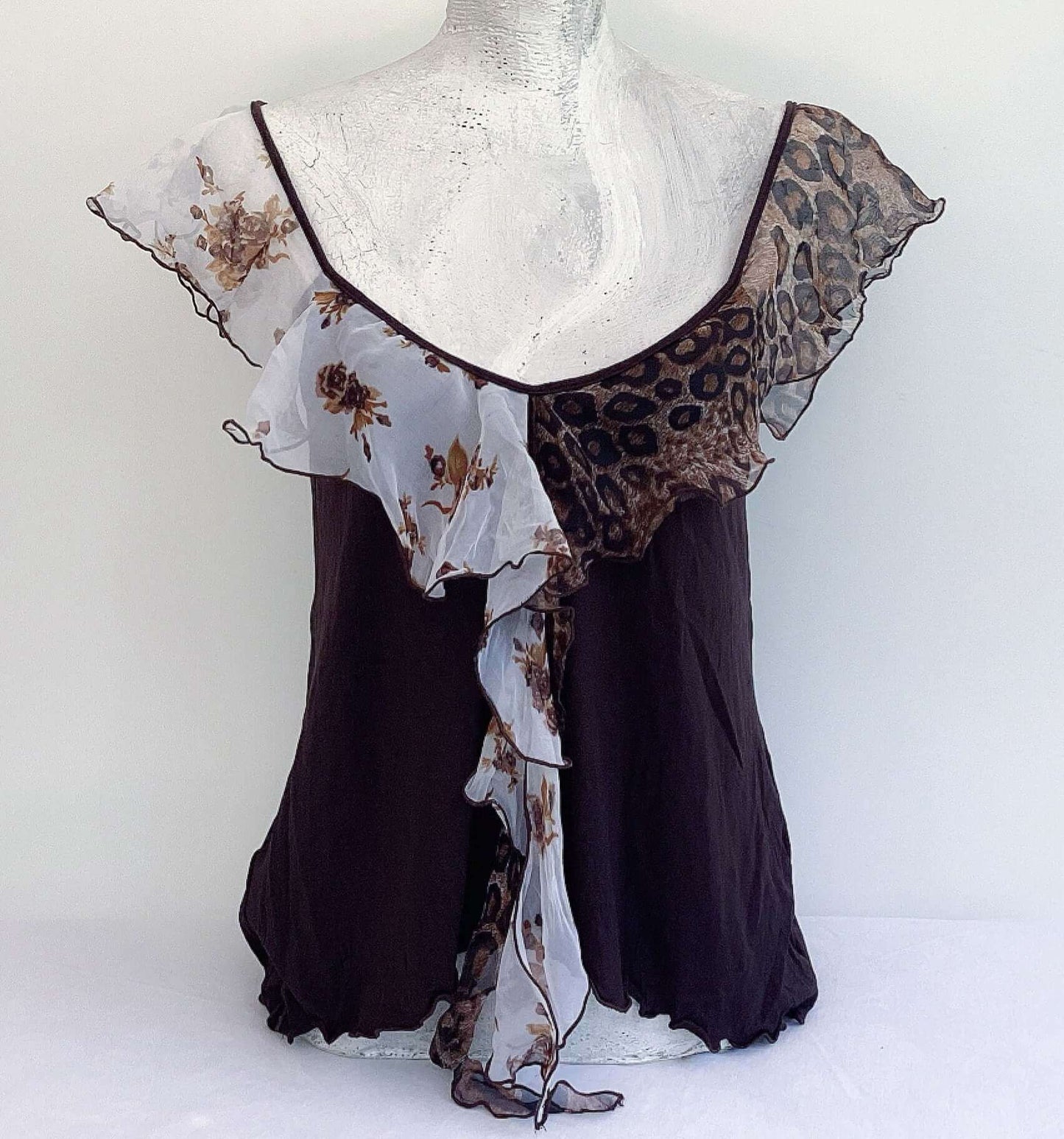 Front view of camisole, contrasting, patterned, wide chiffon frill straps, joining at center bust, flowing down in front.