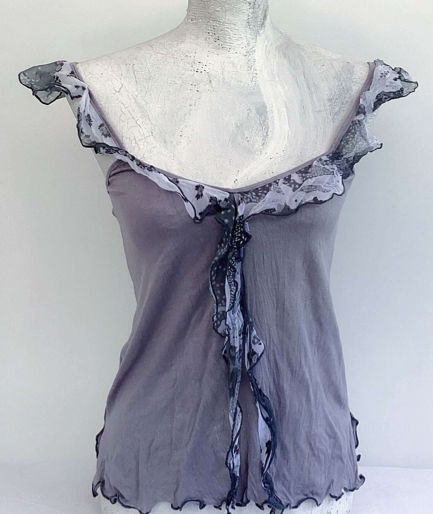 Front view of camisole, contrasting, patterned, wide chiffon frill straps, joining at center bust, flowing down in front.