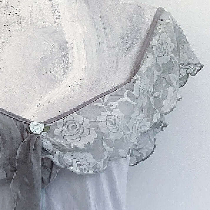 Close up view of lace wide chiffon frill strap, joining at center bust, flowing down in front.