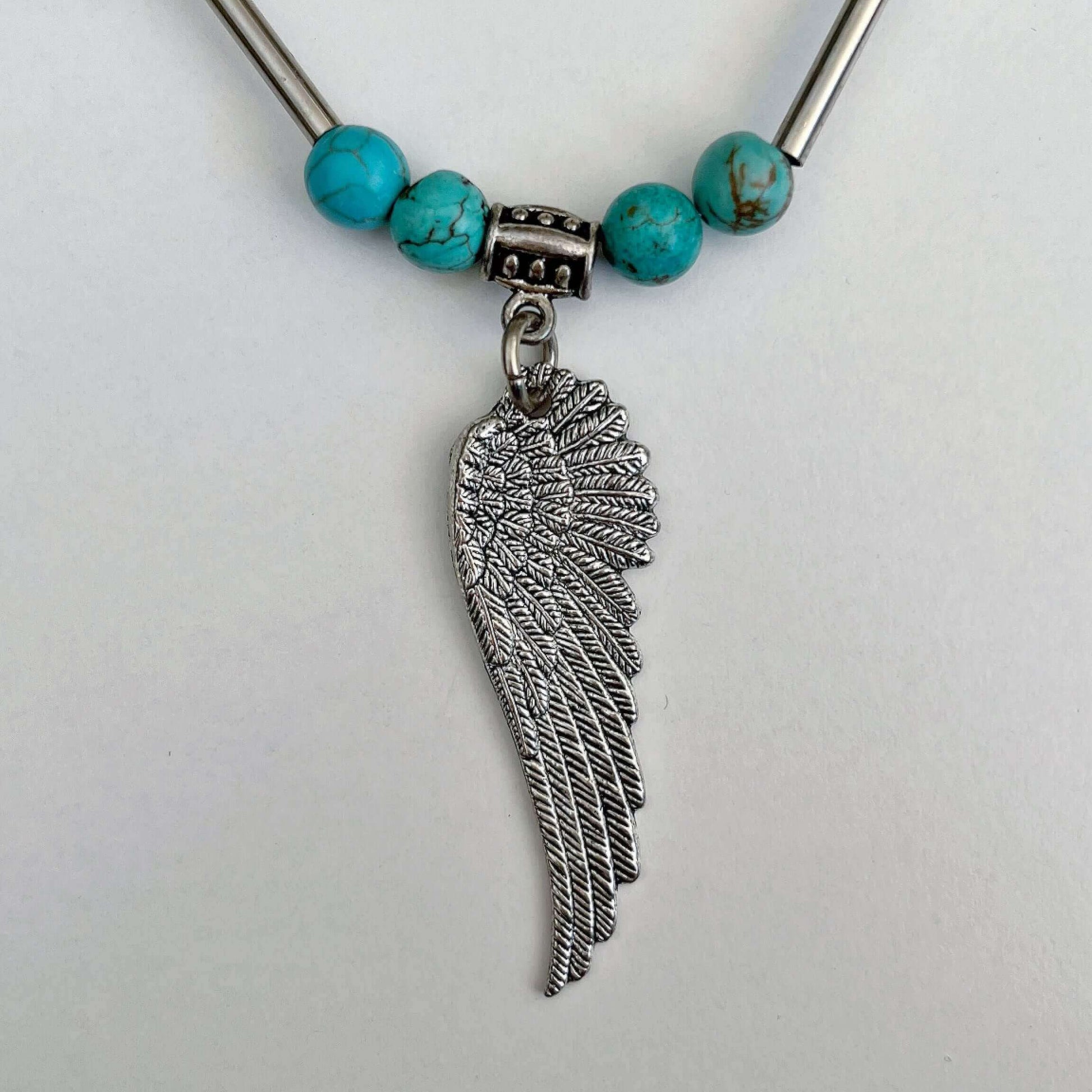 Detail view of the angel wing pendant.