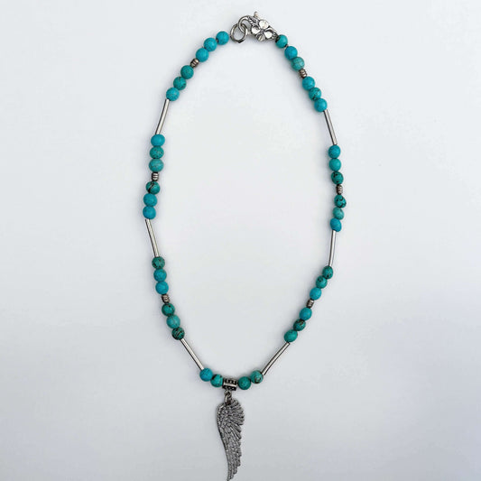 Top view of the Blue Howlite necklace with the angel wing pendant.