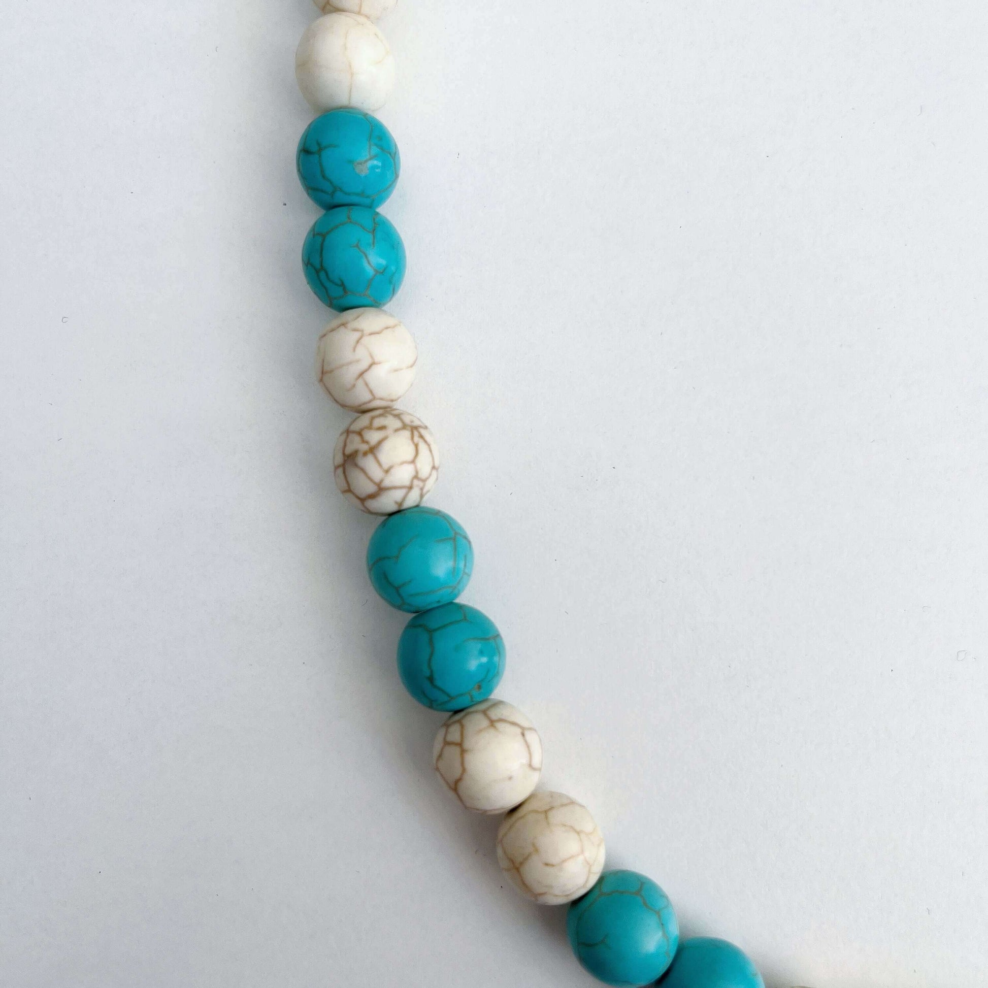 Detail view of the Blue and White Howlite smooth beads.