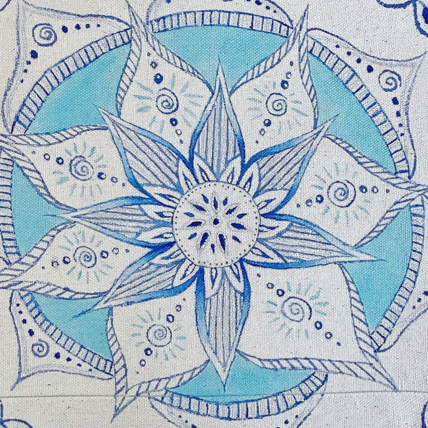 Close up view of canvas tote bag, with large hand painted blue and white mandala on the front.