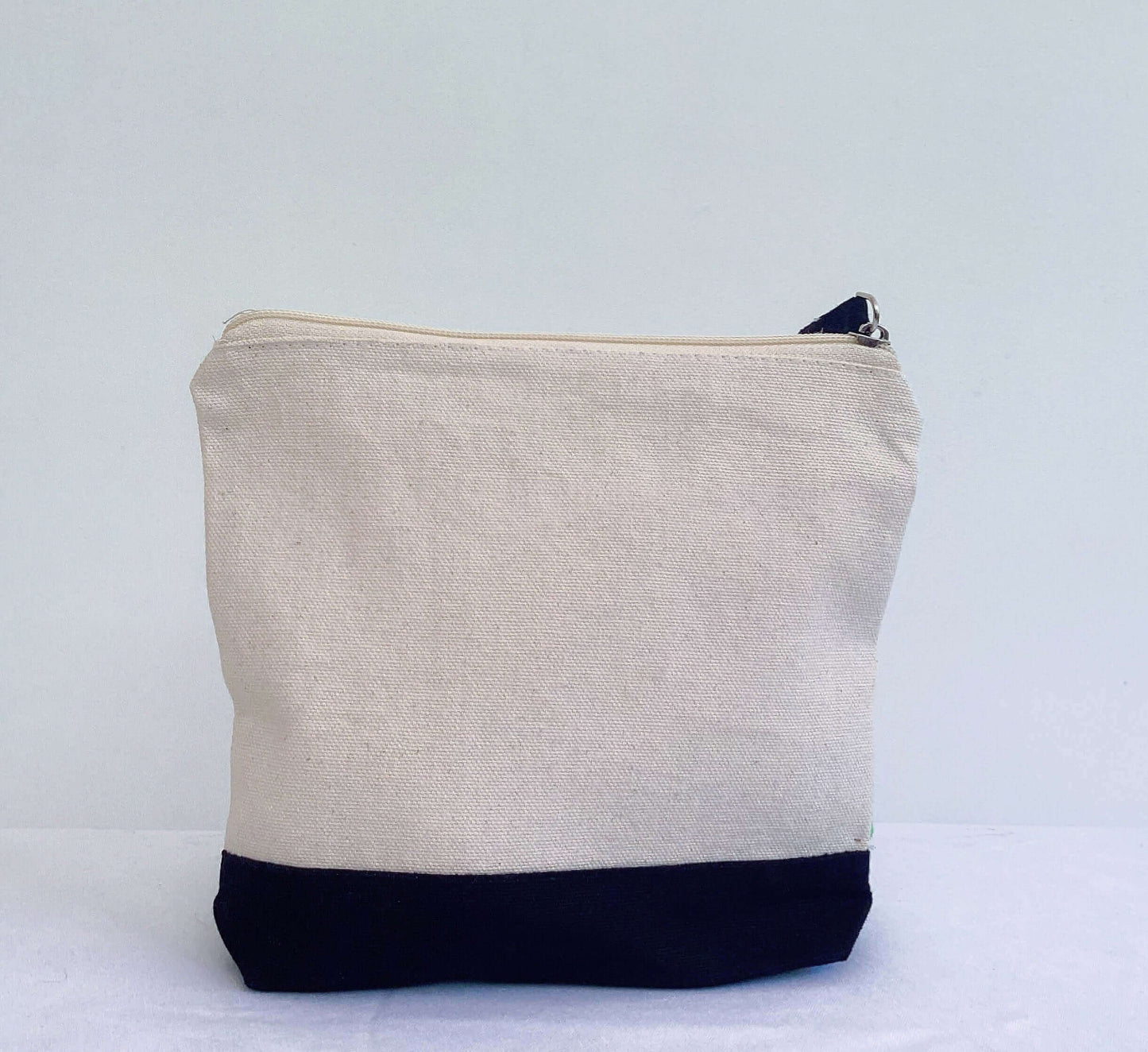 Back view of plain canvas make-up pouch, black canvas base.