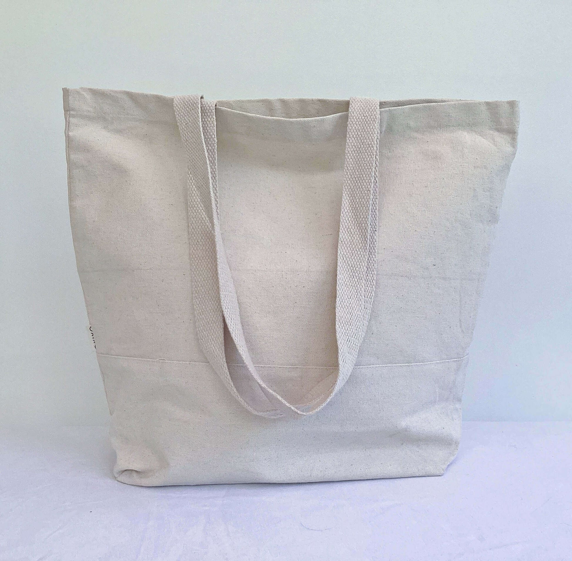 Back view of tote bag which is plain calico, has a gusset so that it can stand.