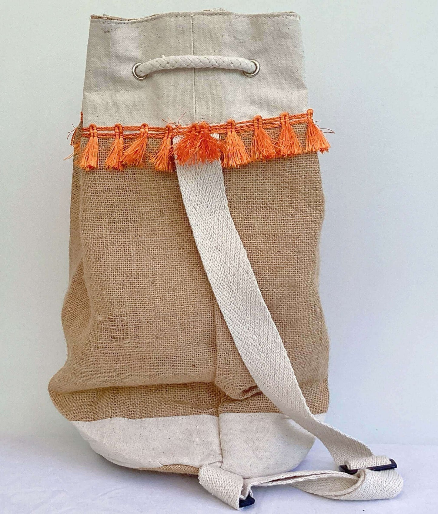 Back view of hessian satchel with orange fringing at the top, white back strap and base.