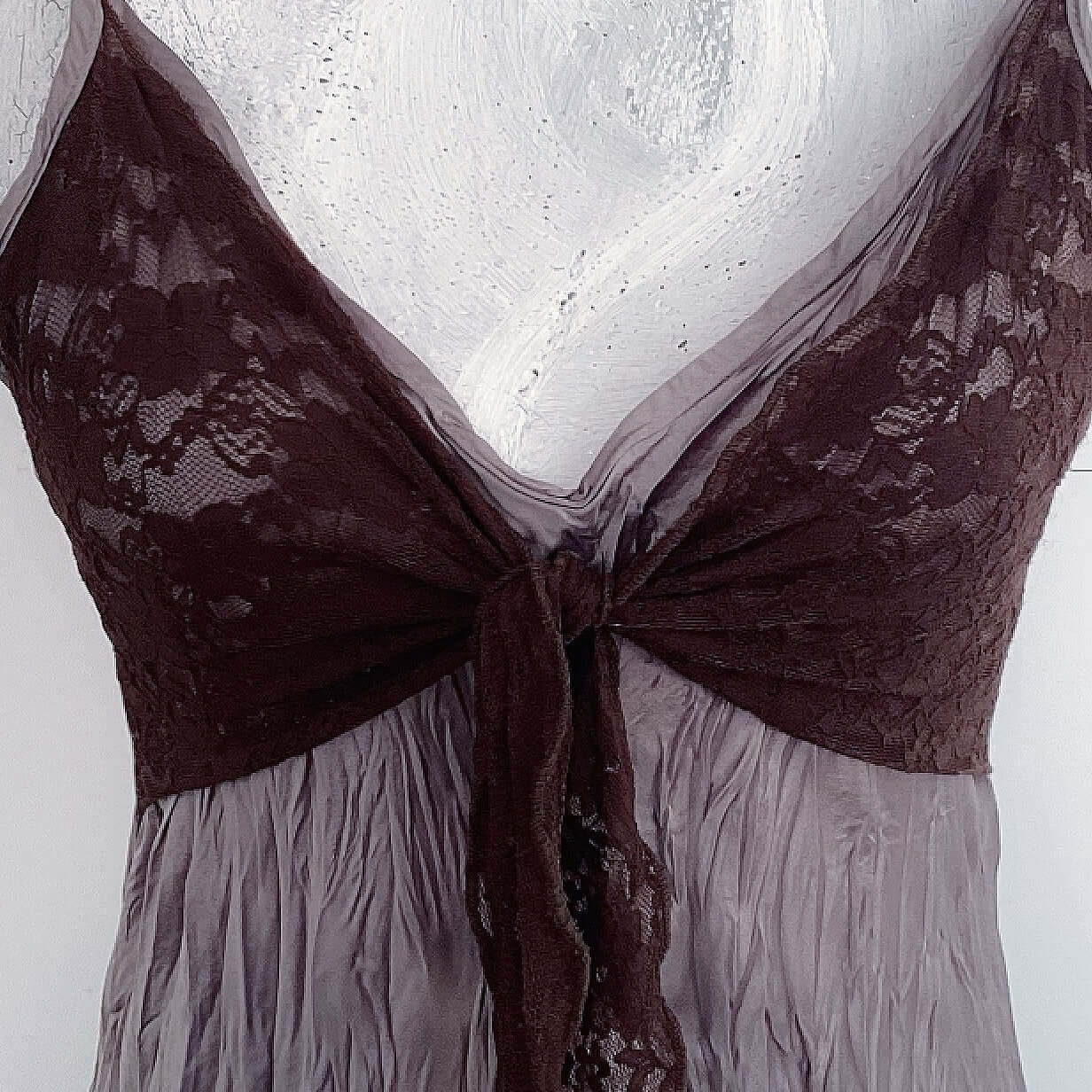 Detail view of the brown stretch lace over the bust, and the crinkled dusty brown matt satin dress fabric.