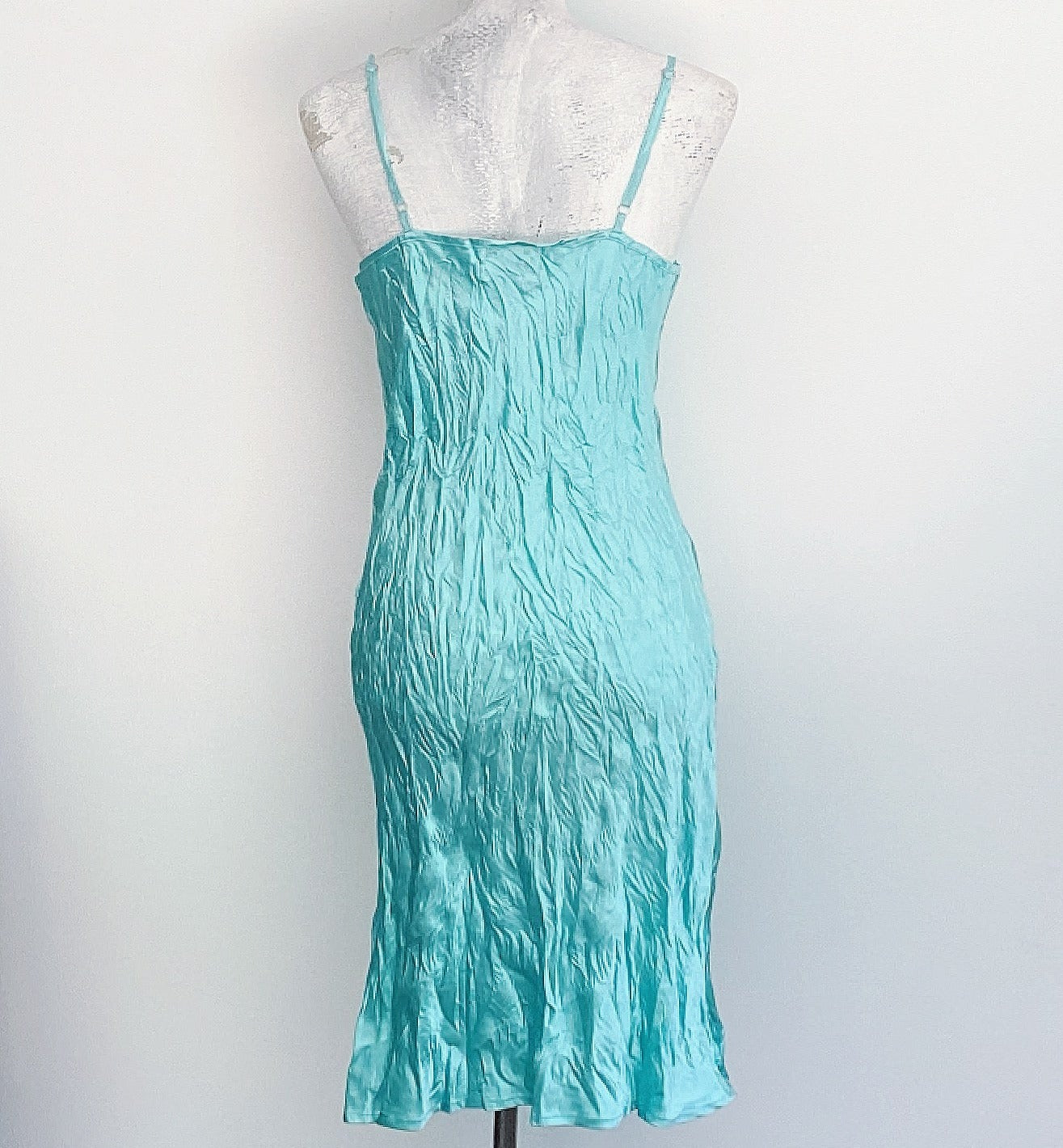 Back view of dress, aquamarine crinkled satin, almost knee length, adjustable straps.