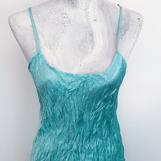 Detail view of dress, aquamarine crinkled satin, almost knee length, adjustable straps.