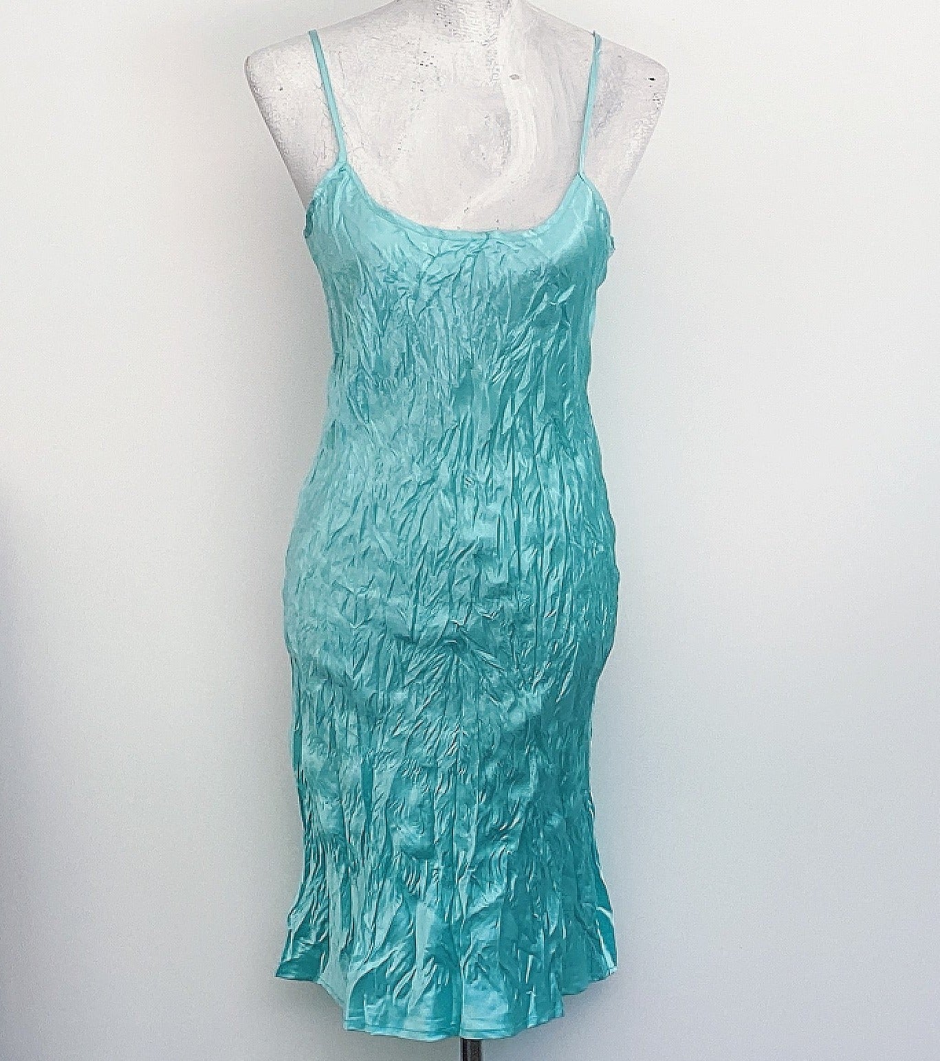 Front view of dress, aquamarine crinkled satin, almost knee length, adjustable straps.