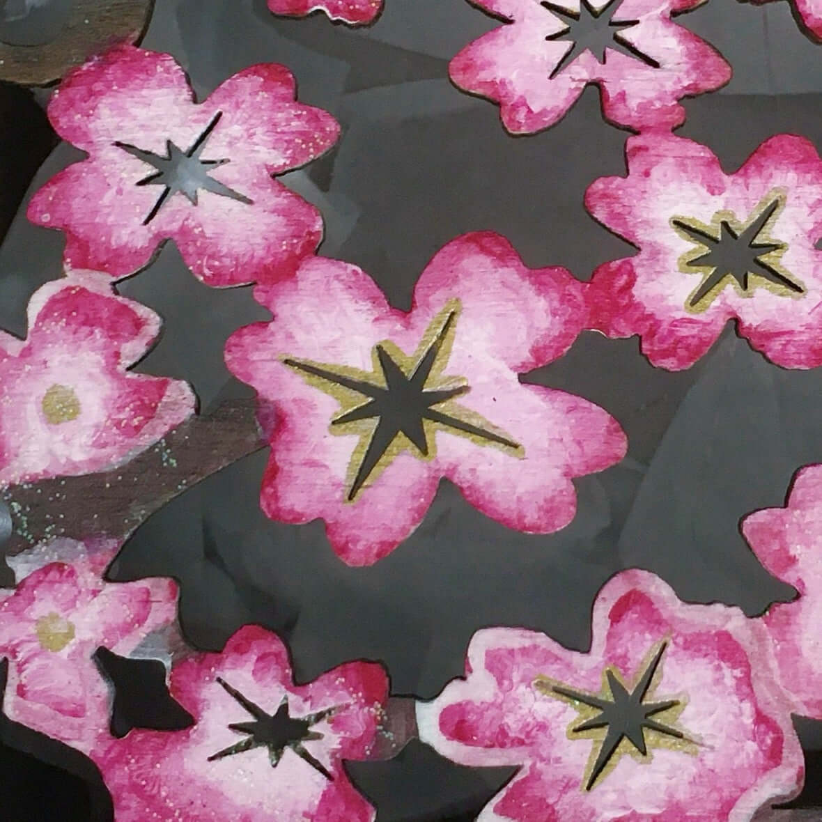 Detail view of pink painted box, fading to white and pink cherry blossom laser cut lid.