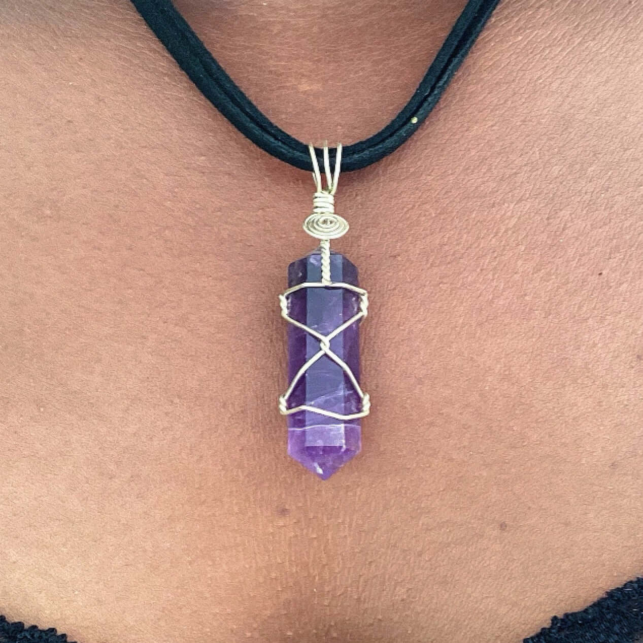 Close up of wire bound amethyst pendant.