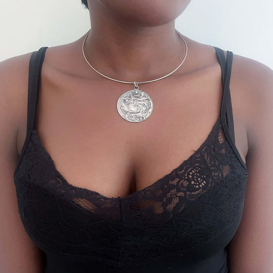 Front view of pewter art nouveau cameo design, on metal choker.