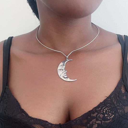 Front view of pewter art nouveau moon, on steel choker