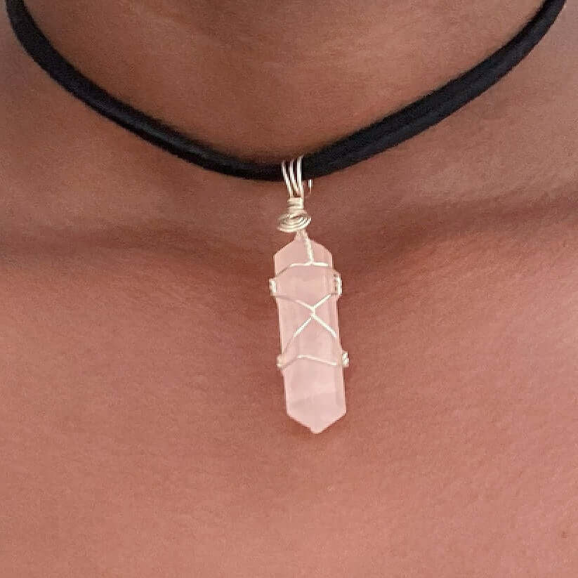 Close up of wire bound rose quartz pendant.