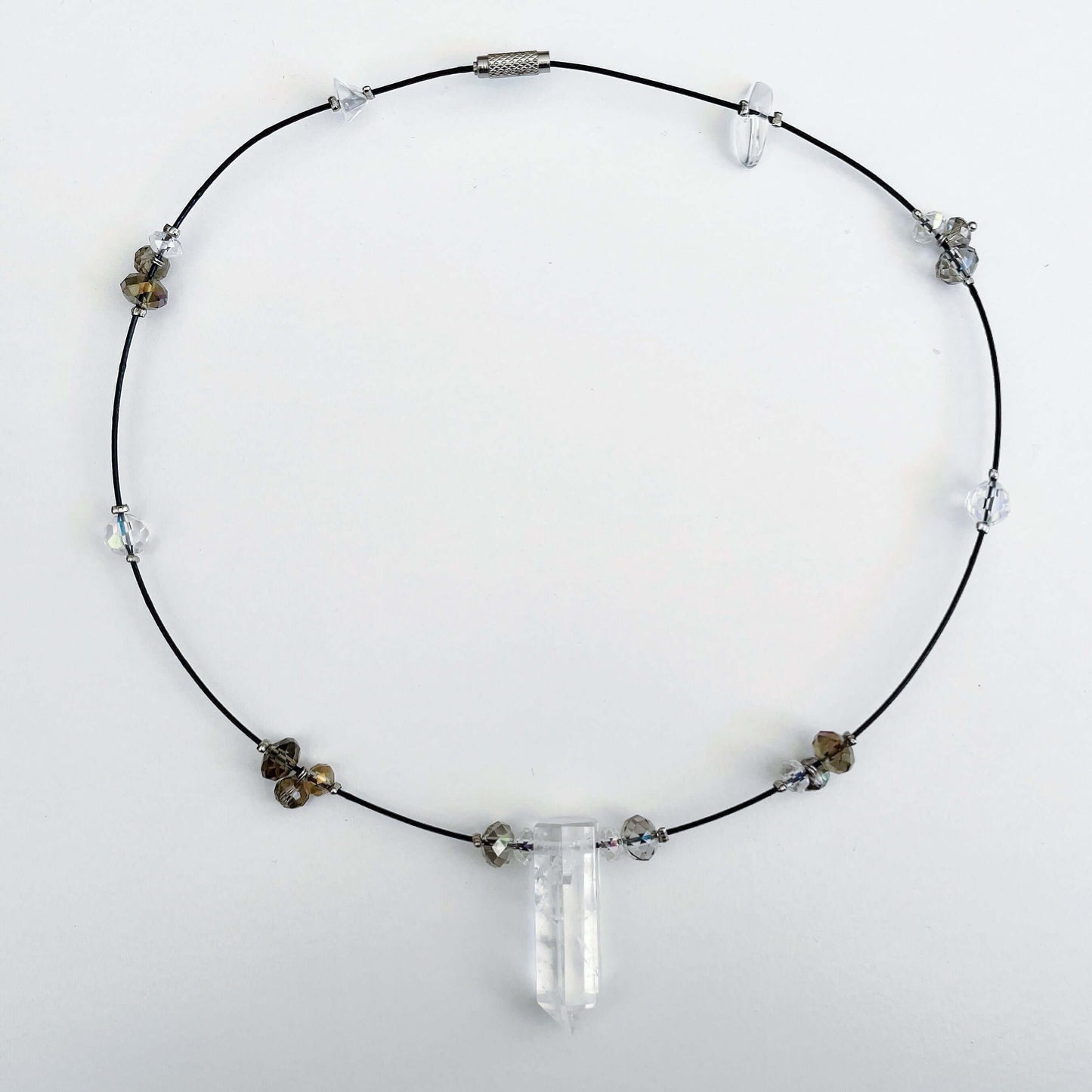 Top view of clear quartz pendant strung onto choker with crystal beads 2cm apart all around.