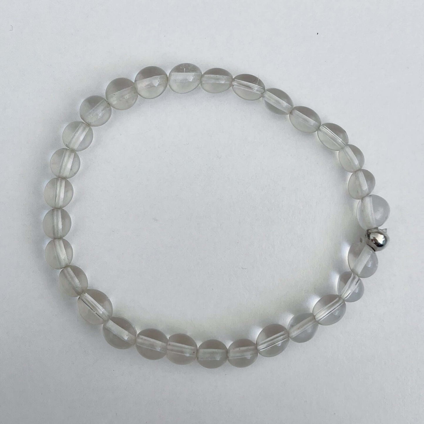 Top view of the elasticated bracelet, in shades of white/clear/opalescent