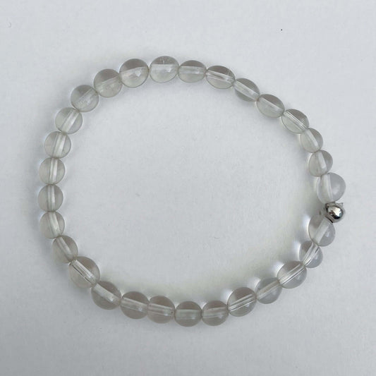 Top view of the elasticated bracelet, in shades of white/clear/opalescent