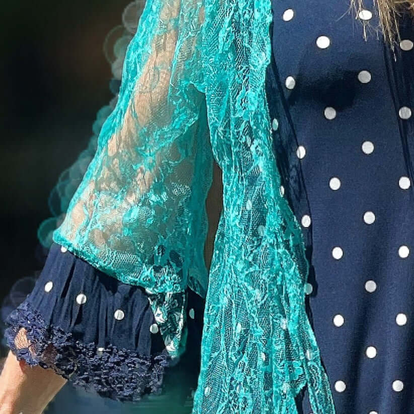 Detail view of aqua lace jacket, with dotted navy lycra cuff at the end of the right sleeve.