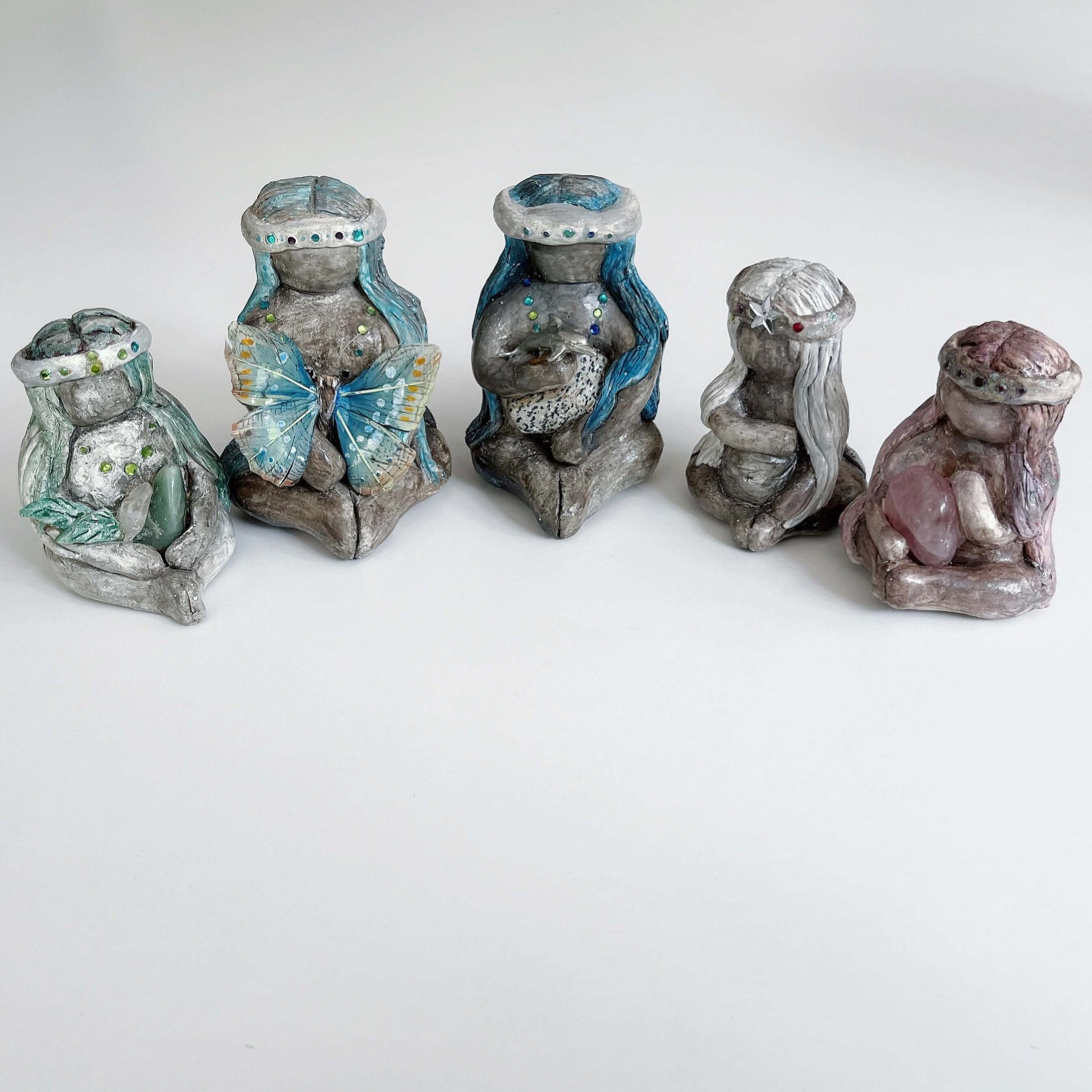 View of five different earth elementals sitting in a line.