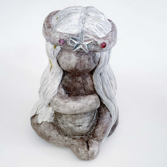 Front of elemental, brown wash painted figure, jewel band and star on head, beige long hair, gently holding a preggy tummy.
