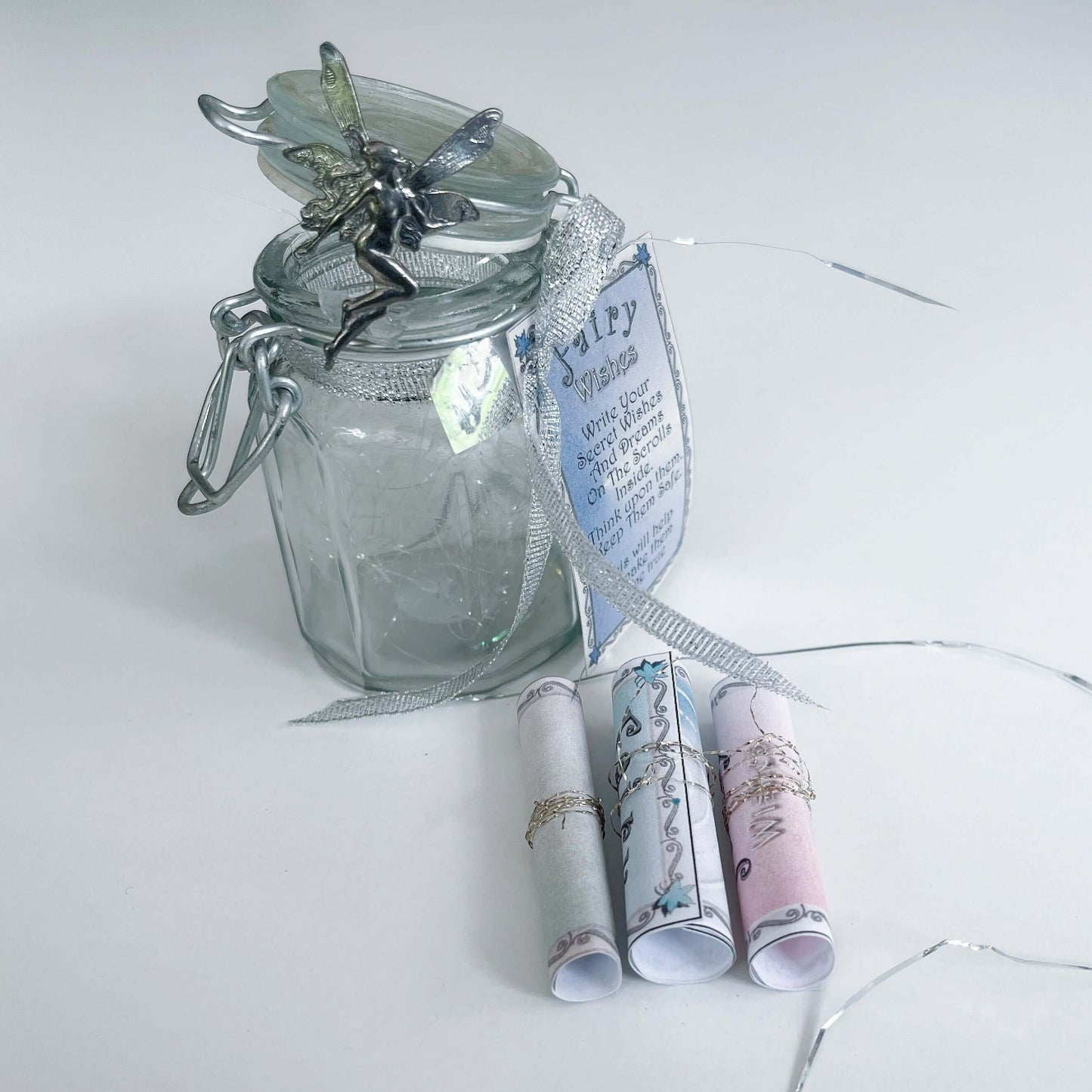 View of the three bound fairy scrolls shown next to the bottle.