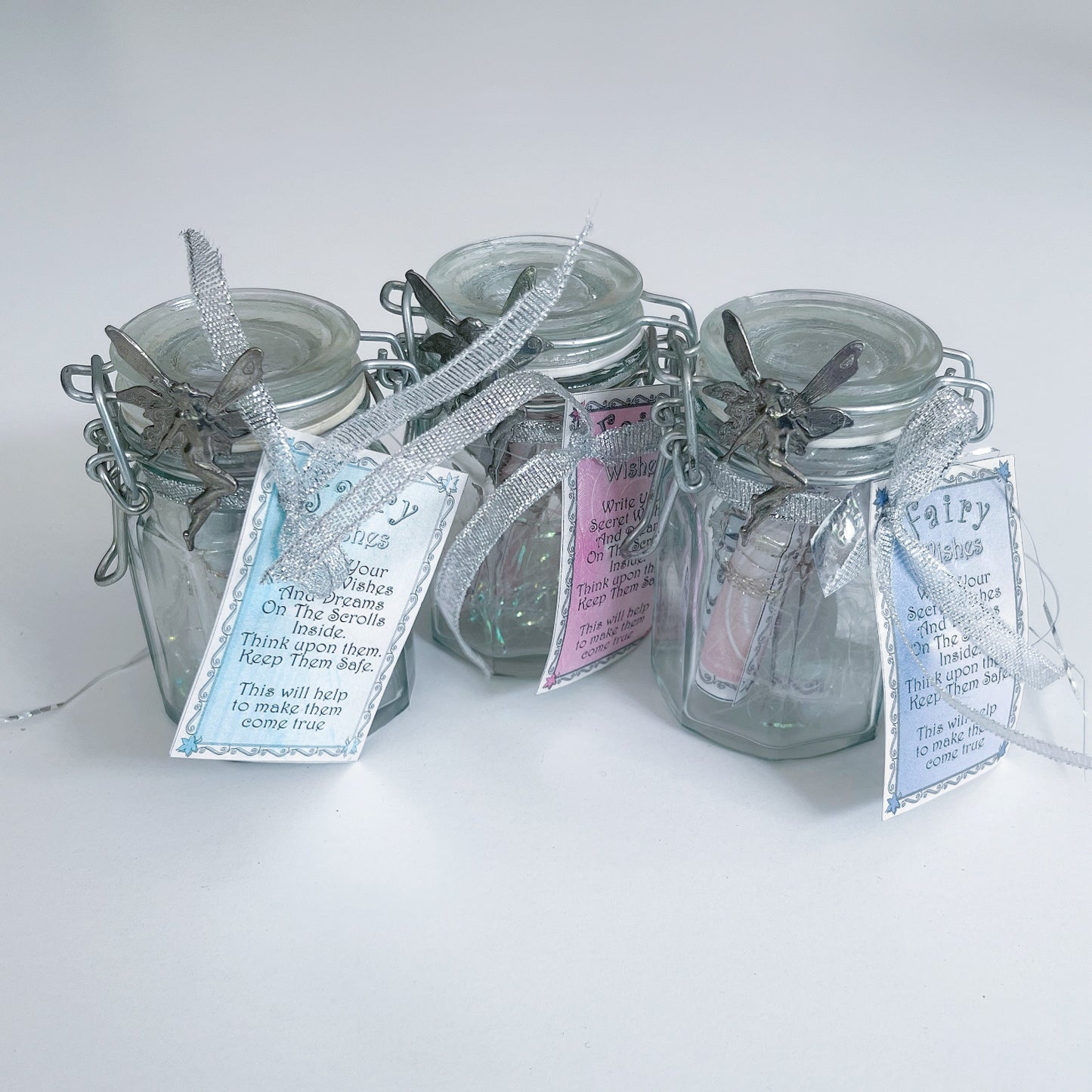 View of three Fairy Wish bottle standing in a group together.