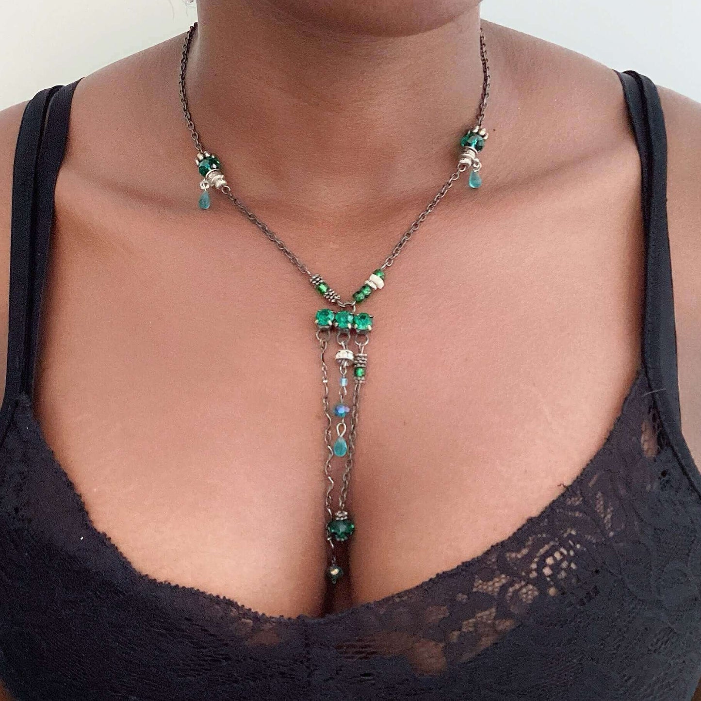 Y shaped chain necklace, green crystal stations, then central green crystal cluster, 3 shorter chains dangling from center.