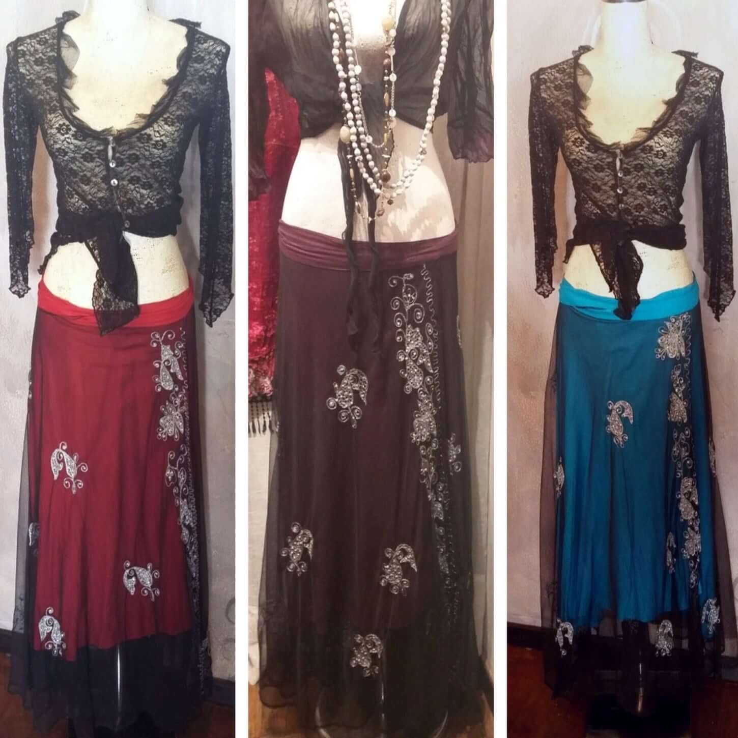 Group of three different gypsy skirts, a red, a turquoise, and a plum.